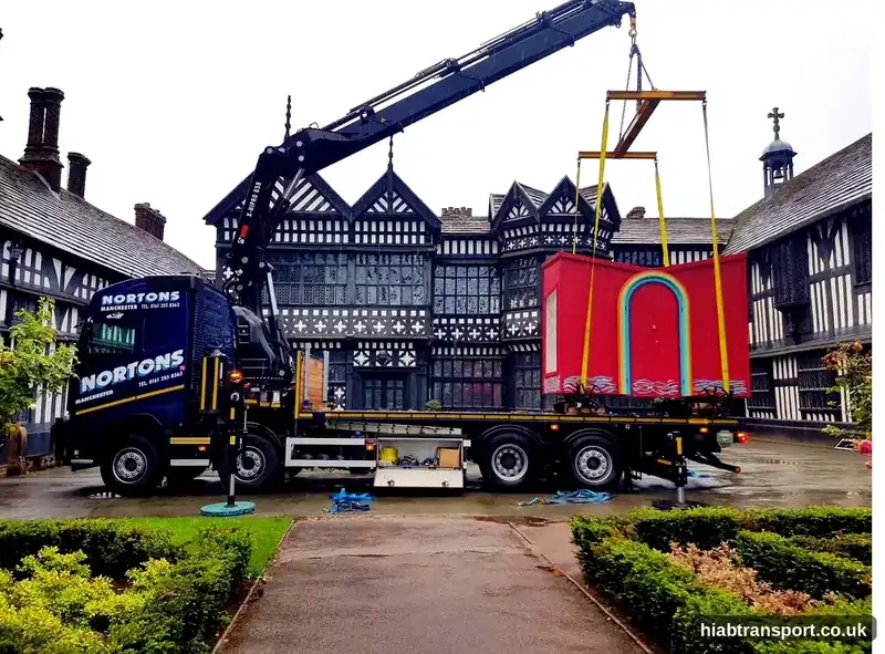 HIAB crane lifting a decorative cabin at a historic venue, North West UK