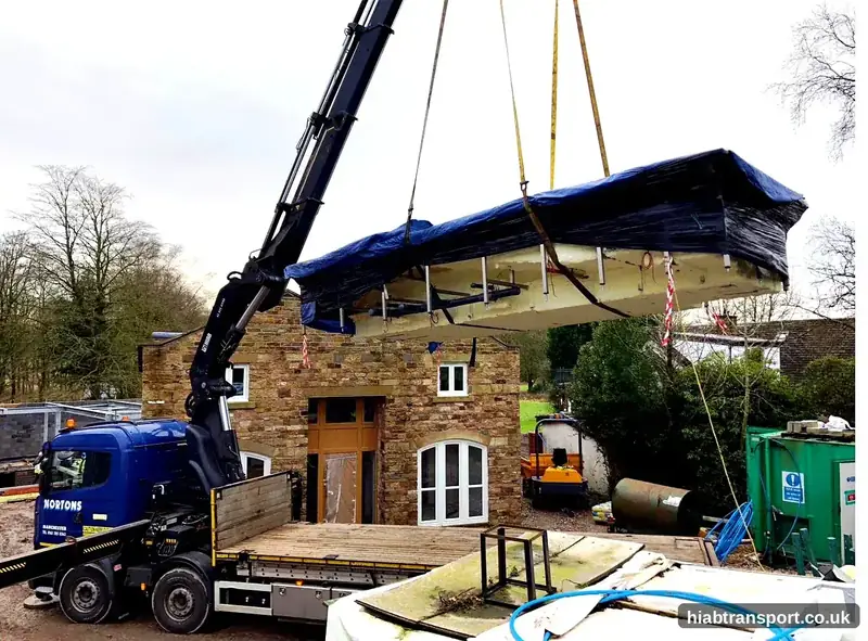 HIAB crane lifting a structure on a rooftop in the North West