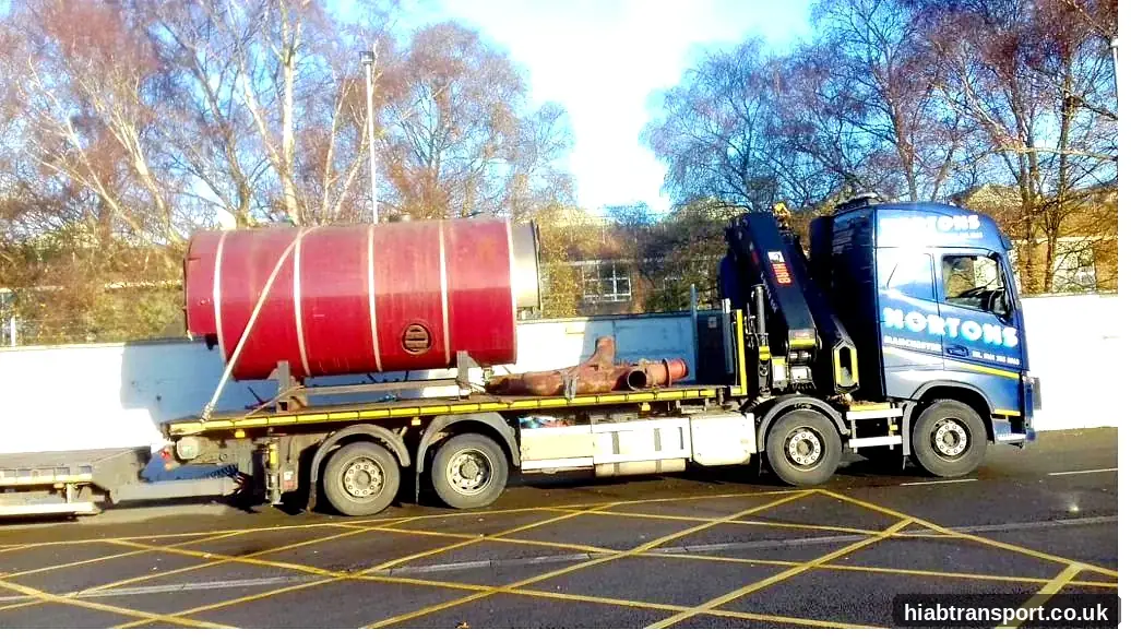 Industrial tank secured on a flatbed crane lorry for UK delivery